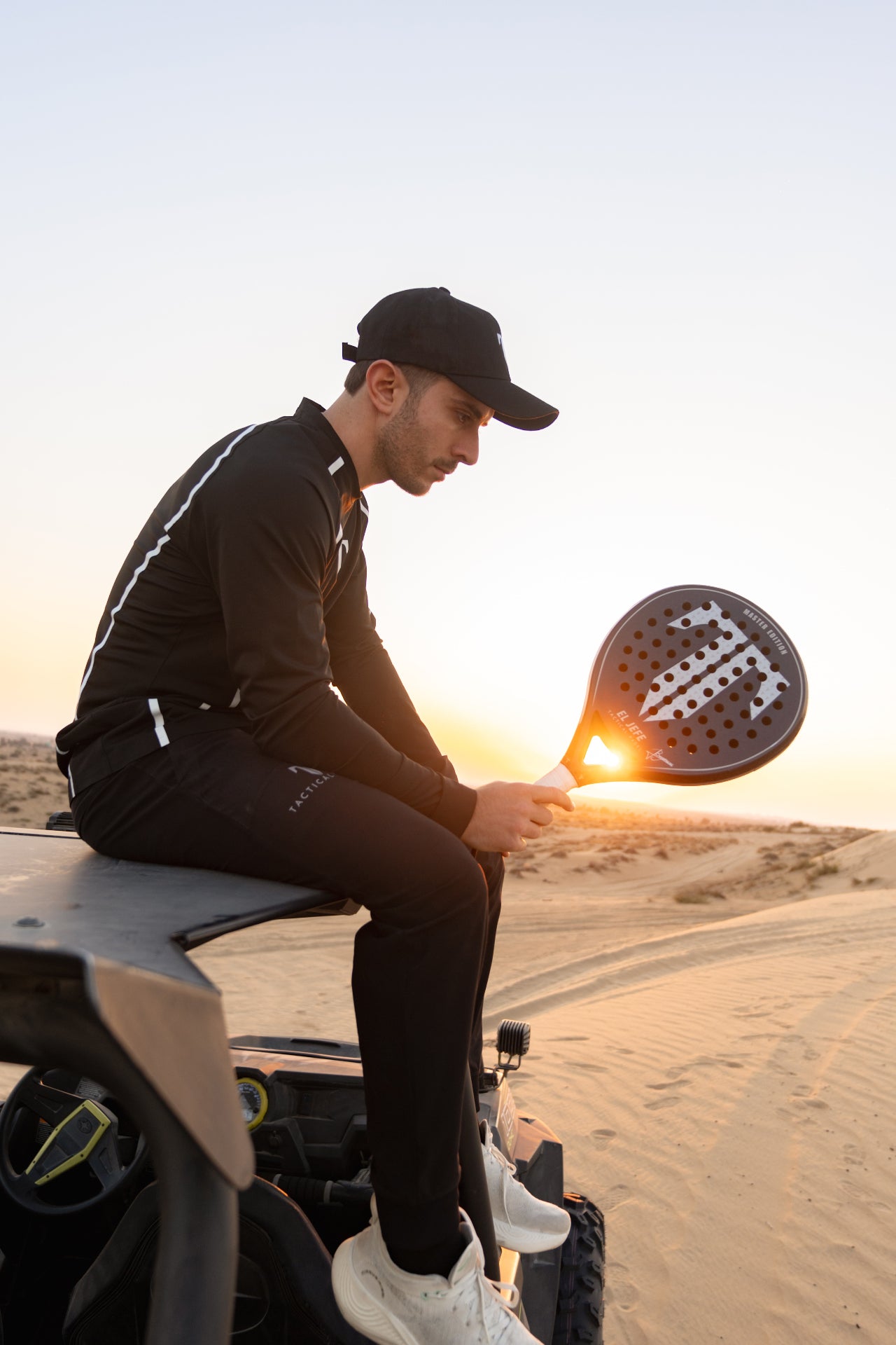 Lucas Bergamini standing on a dune buggy in the desert